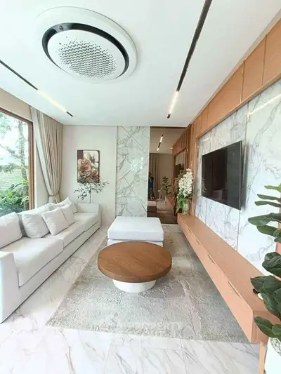 Luxurious modern living room with elegant decor and large windows offering natural light.