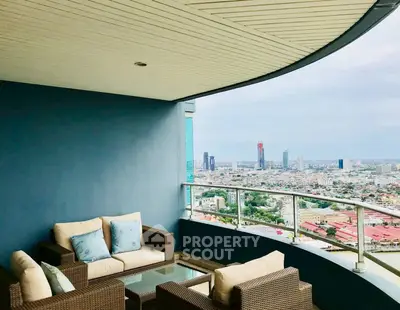Luxurious balcony with stunning city view and cozy seating area