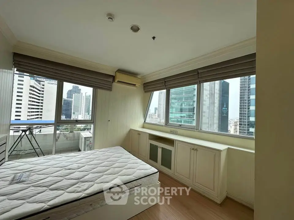 Spacious bedroom with city view and ample natural light