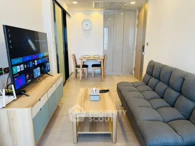 Modern living room with sleek furniture and smart TV, perfect for cozy gatherings.