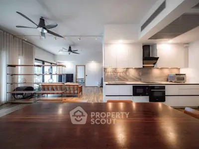 Spacious modern living room with open kitchen and stylish ceiling fans