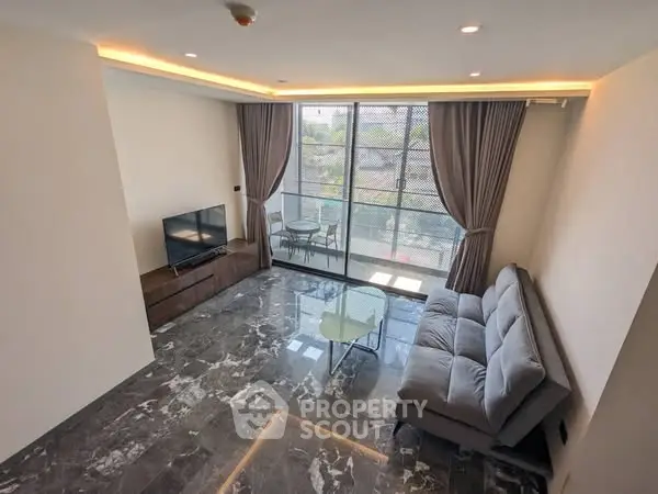 Modern living room with sleek marble flooring and large window view.