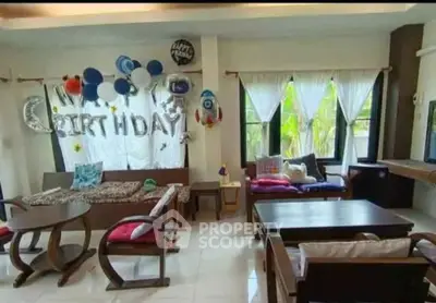 Charming living room with festive birthday decorations and cozy seating area.