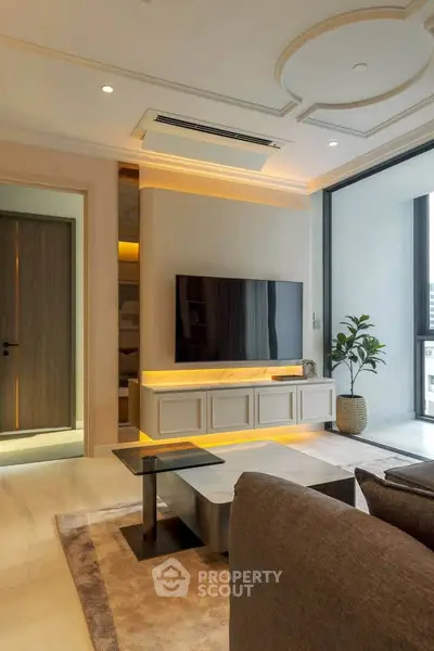 Luxurious modern living room with elegant decor and large TV, featuring stylish lighting and a cozy ambiance.