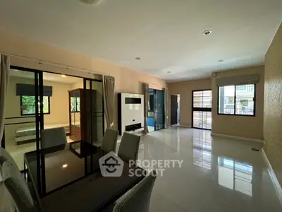 Spacious modern living room with dining area and large windows