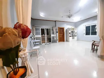 Spacious and elegant living room with modern decor and ample natural light.