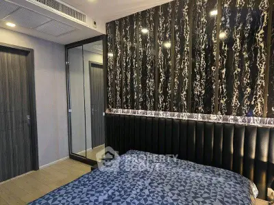 Modern bedroom with stylish wallpaper and mirrored closet doors