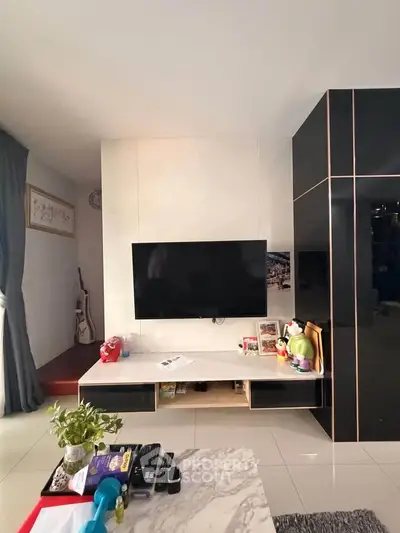 Modern living room with wall-mounted TV and stylish decor