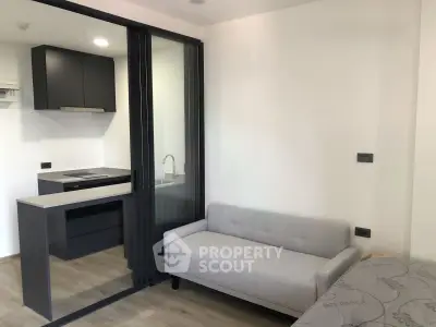 Modern studio apartment with sleek kitchen and cozy living area
