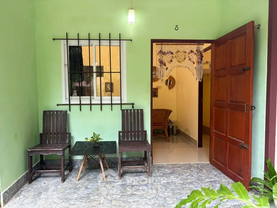Charming entrance with cozy seating area and open door inviting you inside.