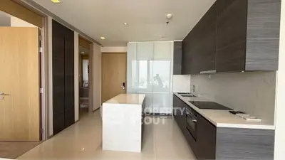Modern kitchen with sleek cabinetry and central island in luxury apartment