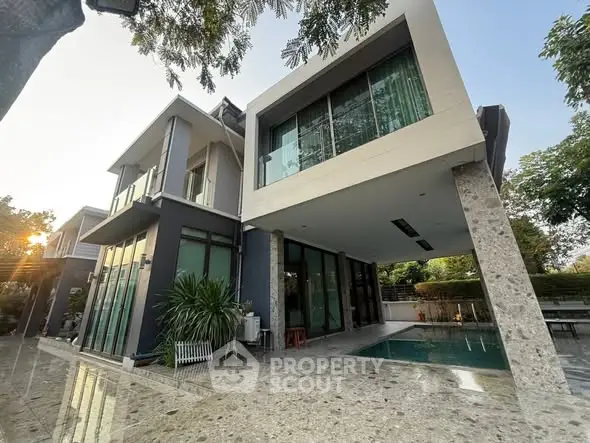 Modern luxury home with sleek architecture and private pool in serene setting.