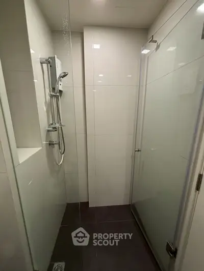Modern bathroom with sleek glass shower enclosure and contemporary fixtures.