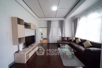 Spacious living room with modern furniture and large windows for natural light.