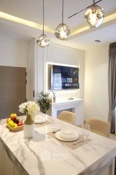 Modern kitchen with marble island and stylish lighting