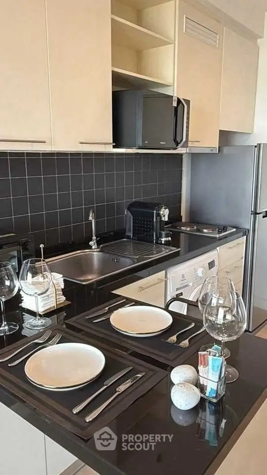 Modern kitchen with sleek black countertops and built-in appliances