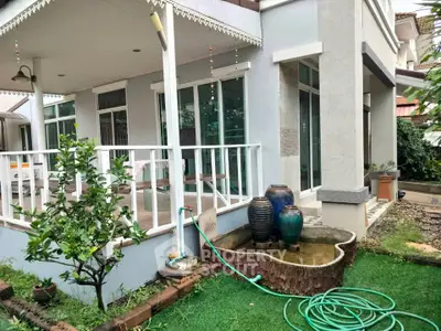 Charming garden view with patio and decorative water feature in modern home exterior.