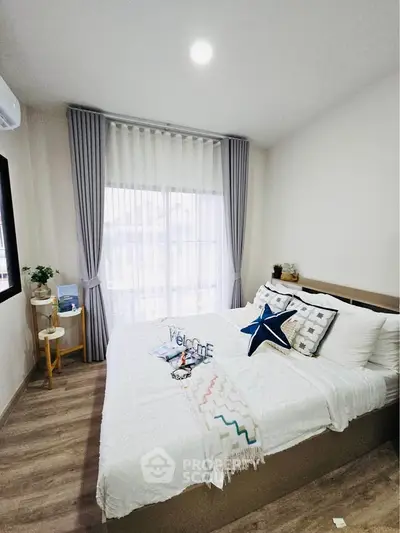 Cozy modern bedroom with stylish decor and natural light