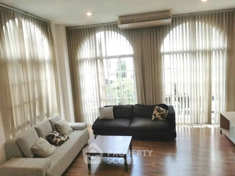 Spacious living room with elegant curtains and modern furniture