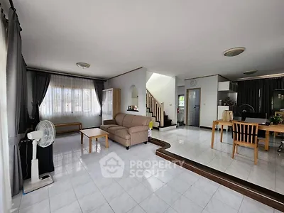 Spacious living room with modern open layout and elegant staircase