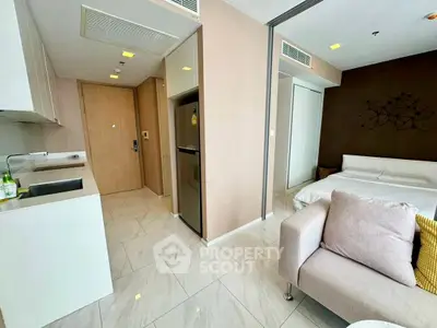 Modern studio apartment with open layout, featuring a cozy living area, compact kitchen, and stylish bedroom.