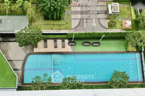 Stunning aerial view of luxurious swimming pool in modern residential complex.