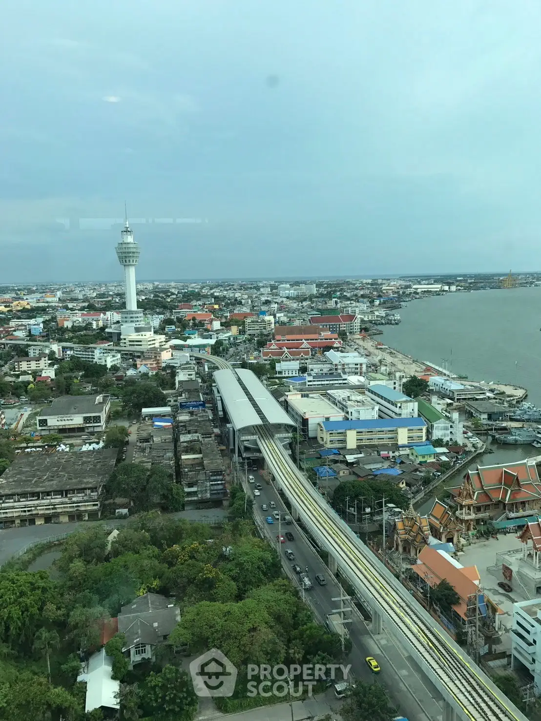 Stunning cityscape view from high-rise building overlooking urban landscape and river.