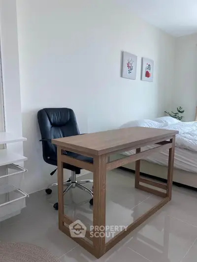 Modern bedroom with sleek desk and ergonomic chair, perfect for a stylish home office setup.