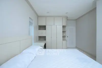 Spacious bedroom with built-in storage and minimalist design