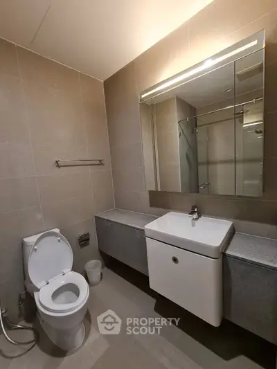 Modern bathroom with sleek design and elegant fixtures in a contemporary real estate property.