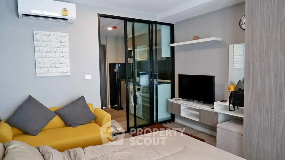 Modern studio apartment with cozy living area and sleek kitchen