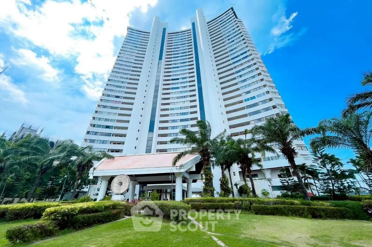 Stunning high-rise building with lush landscaping and clear blue sky