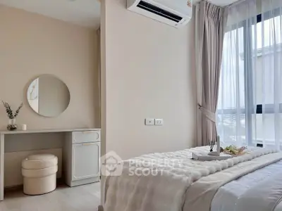 Cozy bedroom with modern decor, featuring a plush bed, stylish vanity, and large window for natural light.
