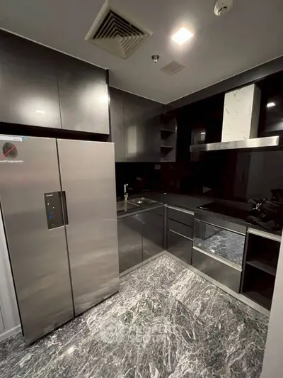 Modern kitchen with sleek appliances and marble flooring