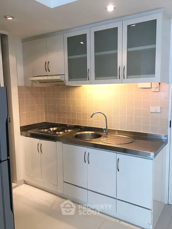 Modern kitchen with sleek cabinets and stainless steel sink