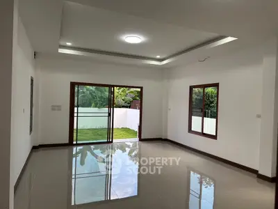 Spacious modern living room with large windows and garden view