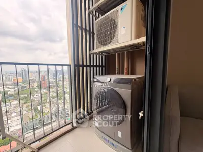 High-rise balcony with city view featuring washing machine and air conditioning unit.