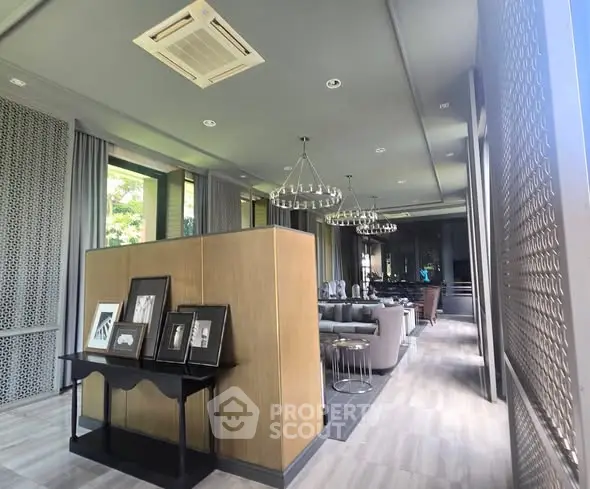 Luxurious modern living room with elegant decor and large windows offering natural light.