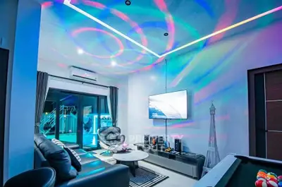 Modern living room with vibrant LED lighting and sleek furniture design.