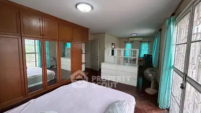 Spacious bedroom with large wardrobe and natural light