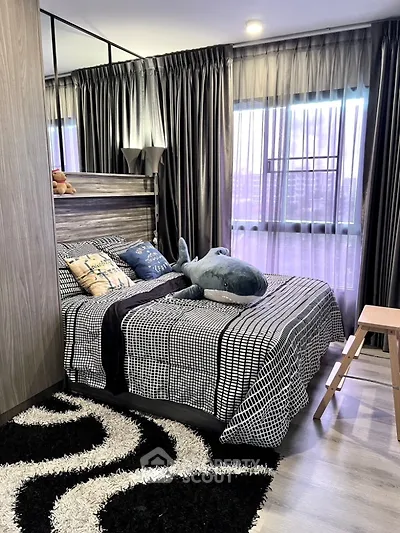 Stylish bedroom with modern decor and large windows for natural light.