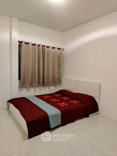 Cozy bedroom with minimalist design and elegant bedding in a modern apartment.