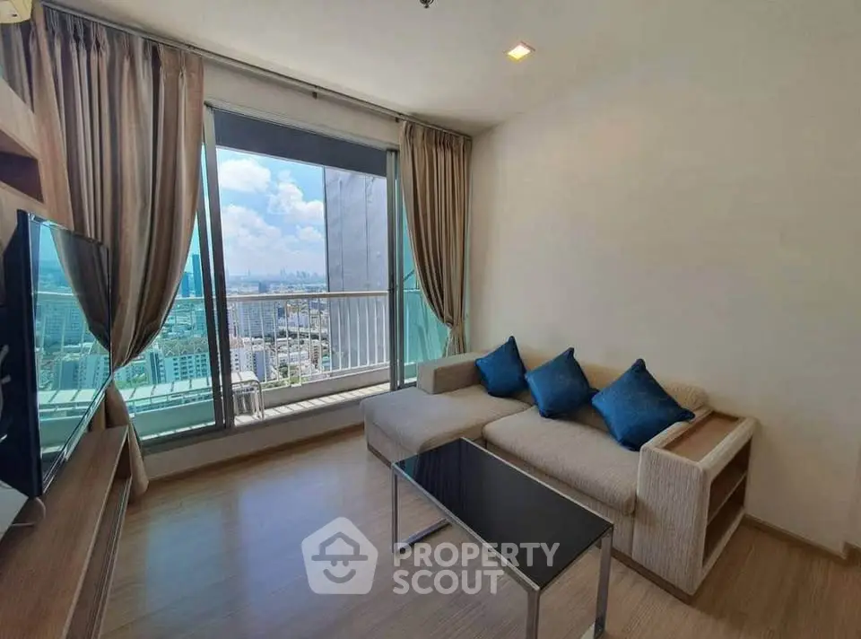 Modern living room with city view, featuring stylish sofa and floor-to-ceiling windows.