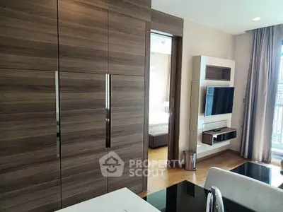 Modern living room with sleek wood paneling and wall-mounted TV