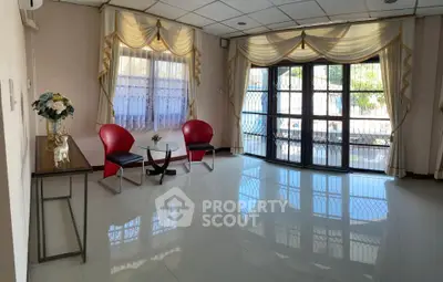 Spacious living room with elegant decor and large windows