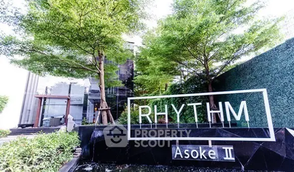Modern condo entrance with lush greenery at Rhythm Asoke II