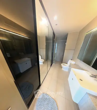 Modern bathroom with sleek design and large mirrors