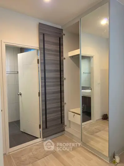 Modern bathroom with sleek design and large mirror in a contemporary home.