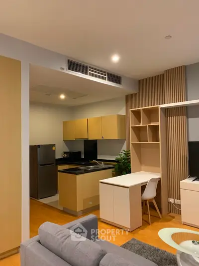 Modern open-layout kitchen with sleek cabinetry and integrated appliances in a stylish apartment.