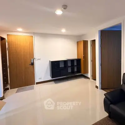 Spacious modern living area with sleek wooden doors and minimalist decor